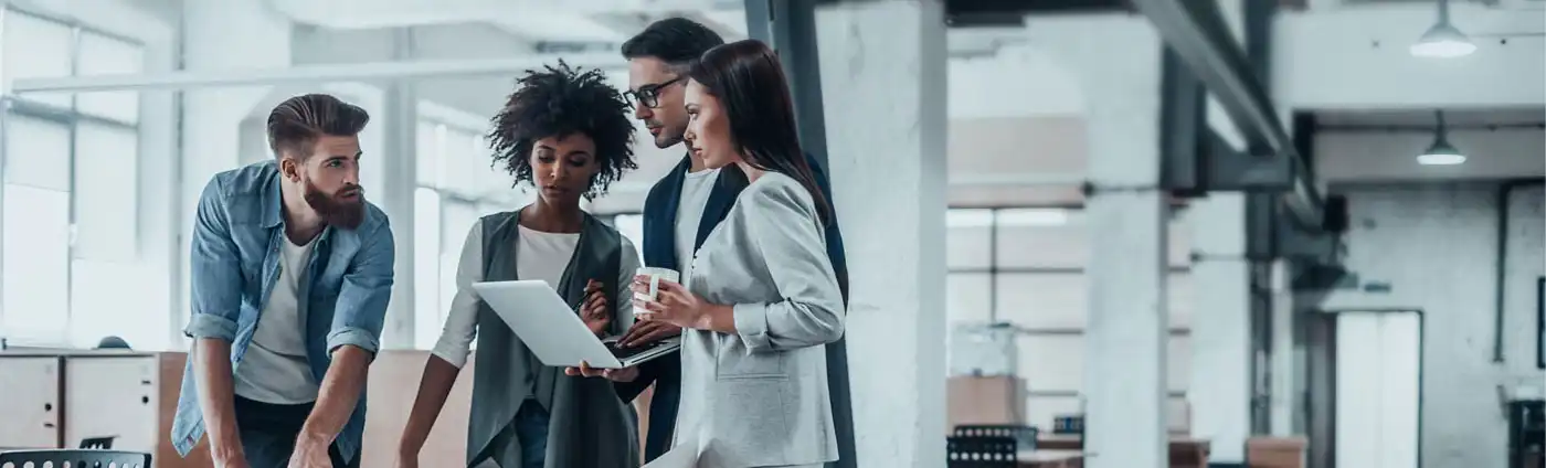 A business group discusses items in a nice looking office