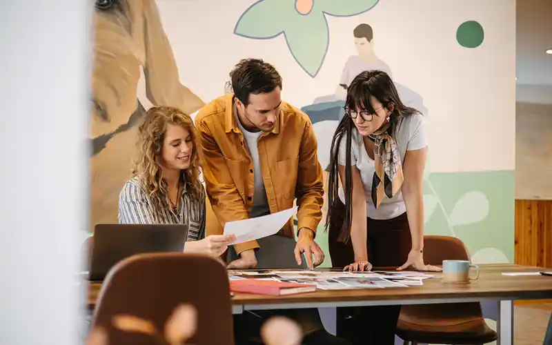 A creative team choosing a front-page photo for a magazine 