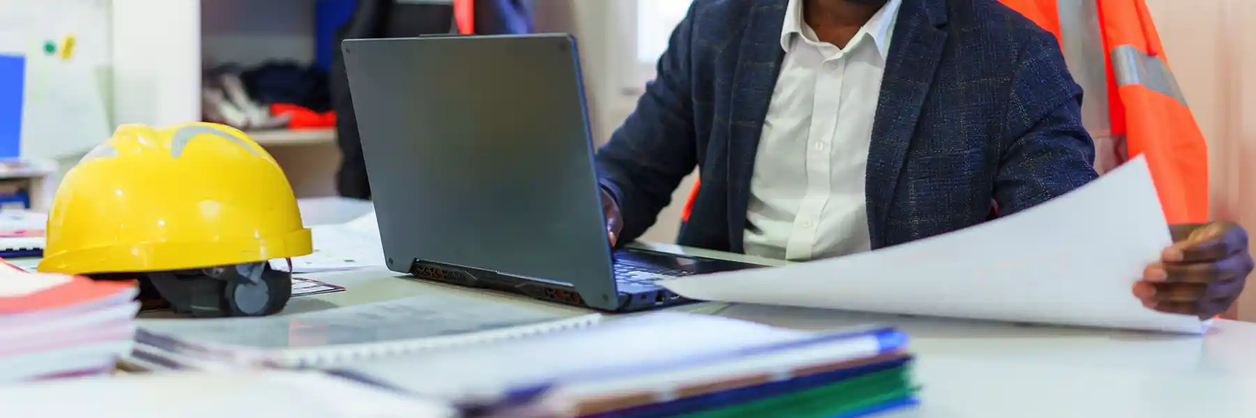 Black civil engineer working planning project with laptop