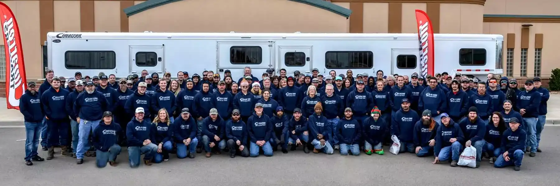 The Cimorron employees pose for a wide angle shot in front of their building