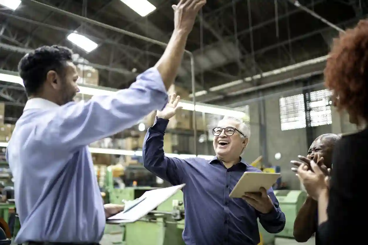 A group of people are excited and high-five each other